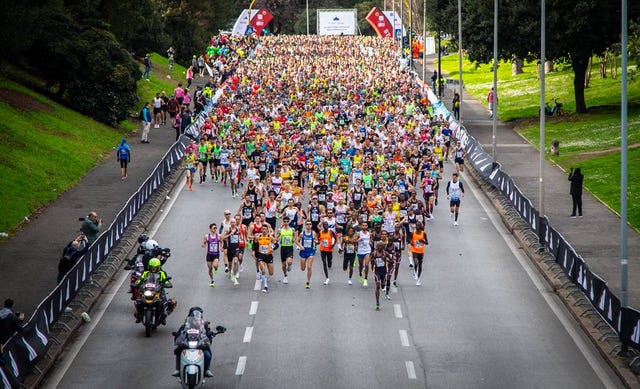 a large group of people running on a road