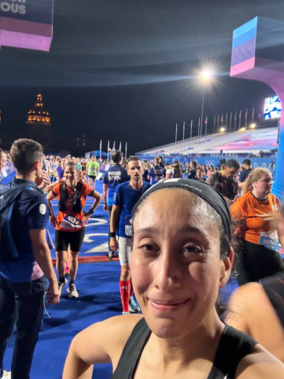 a runner takes a selfie at the finish line of a race