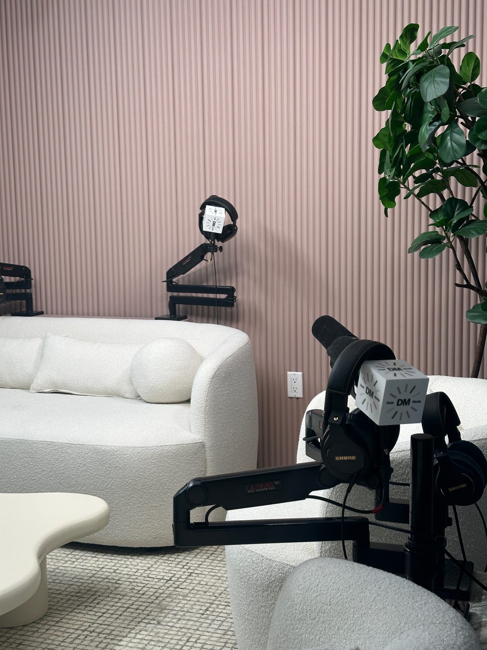 recording studio setup with microphones and seating area