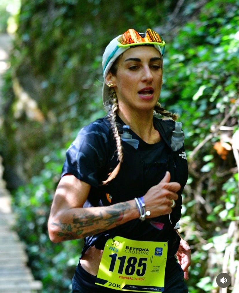 runner participating in a trail race with a visible race number