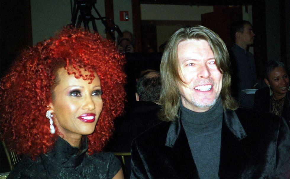 Iman, with bright red hair, with David Bowie, at an Urban League fundraiser