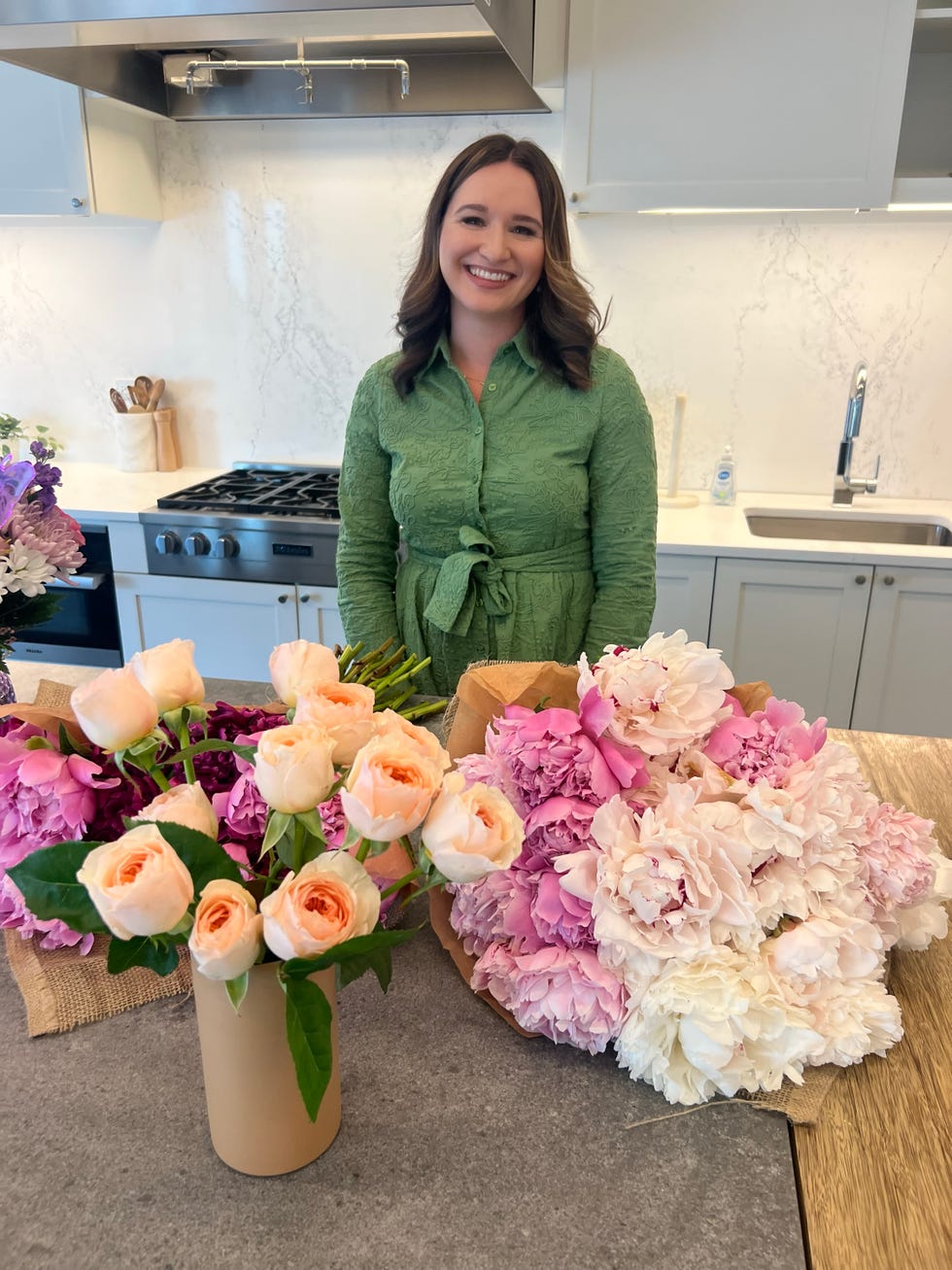 woman standing behind flowers
