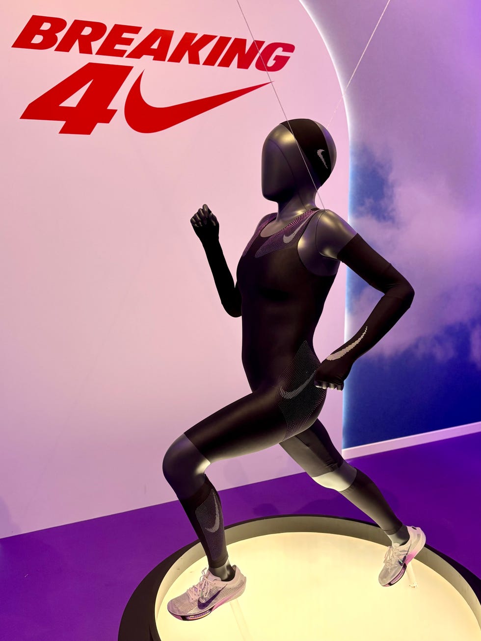 display of a running mannequin wearing a nike speed suit