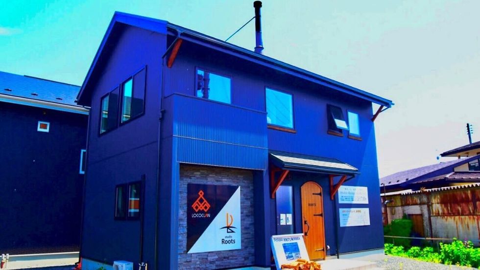 a blue building with a sign on the door