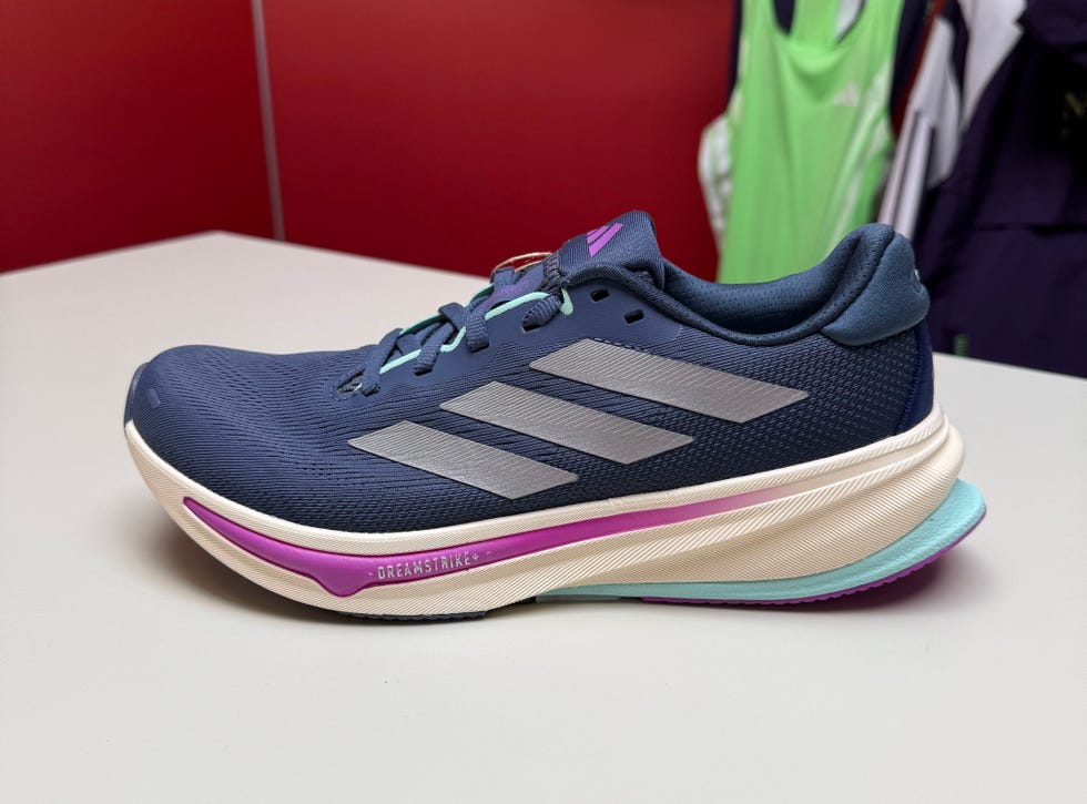 running shoe with a blue upper and distinctive striped design placed on a table