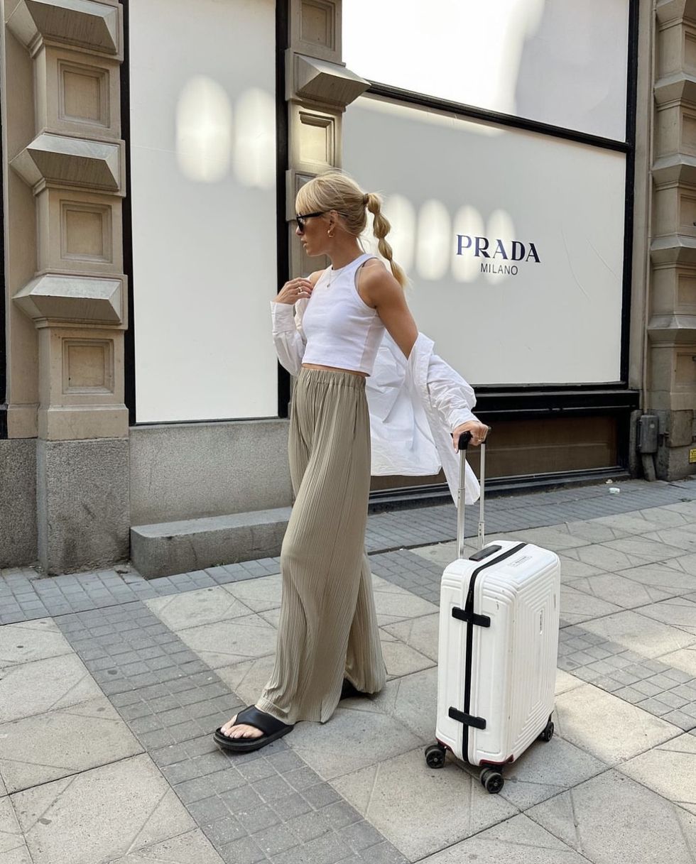 a woman pulling a suitcase