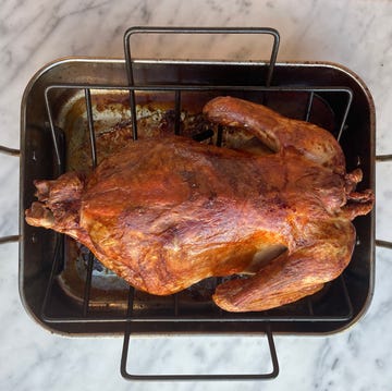 whole roasted turkey in a metal roasting pan whole roasted turkey in a metal roasting pan