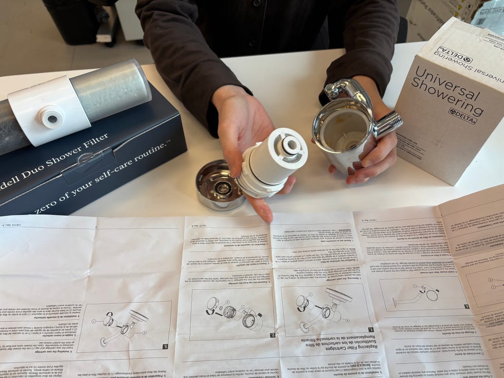 a tester changes the cartridge on a shower filter
