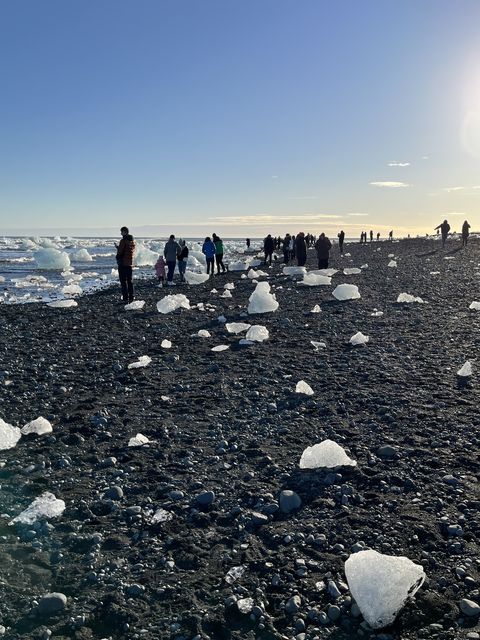diamond beach, a black sand beach where icebergs break apart and pieces wash ashore, appearing to be crystals or diamonds