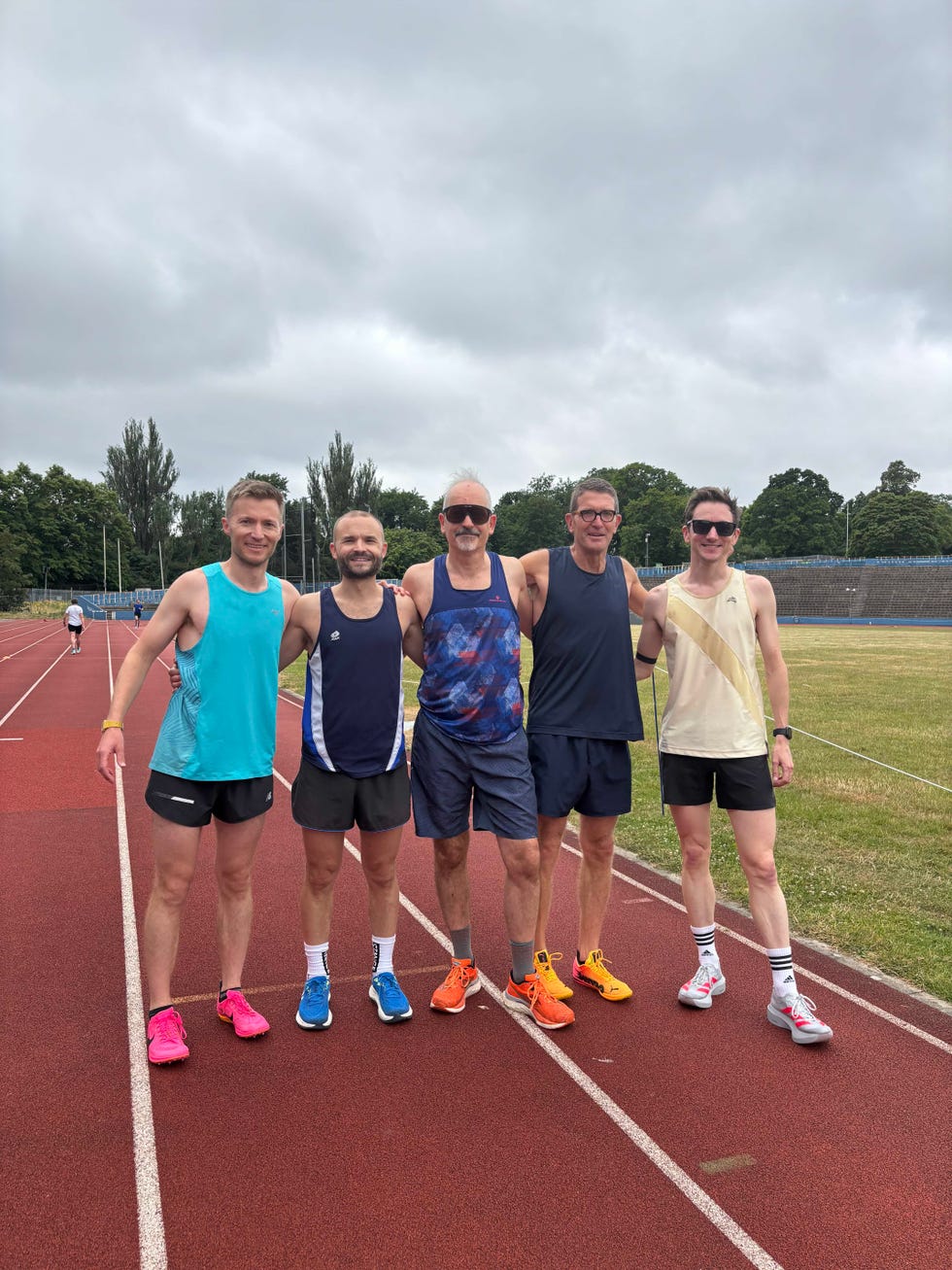 group of runners standing together on a track
