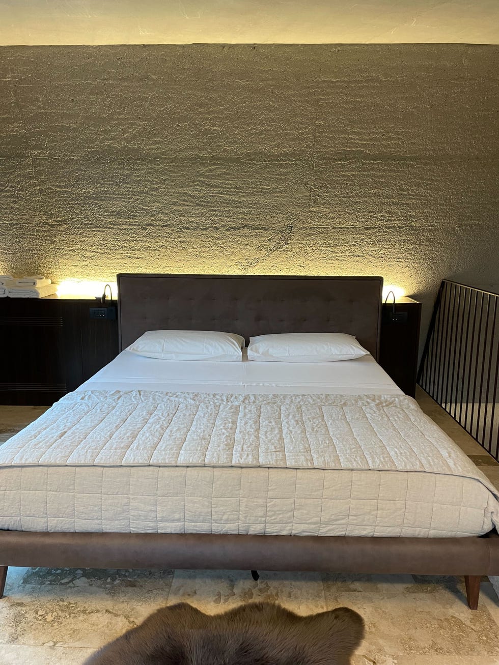 a bed with a wooden headboard