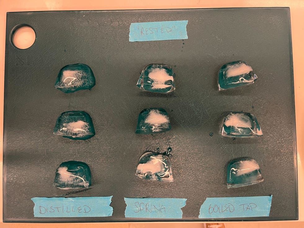 three columns of ice cubes on a green cutting board with blue tape labels