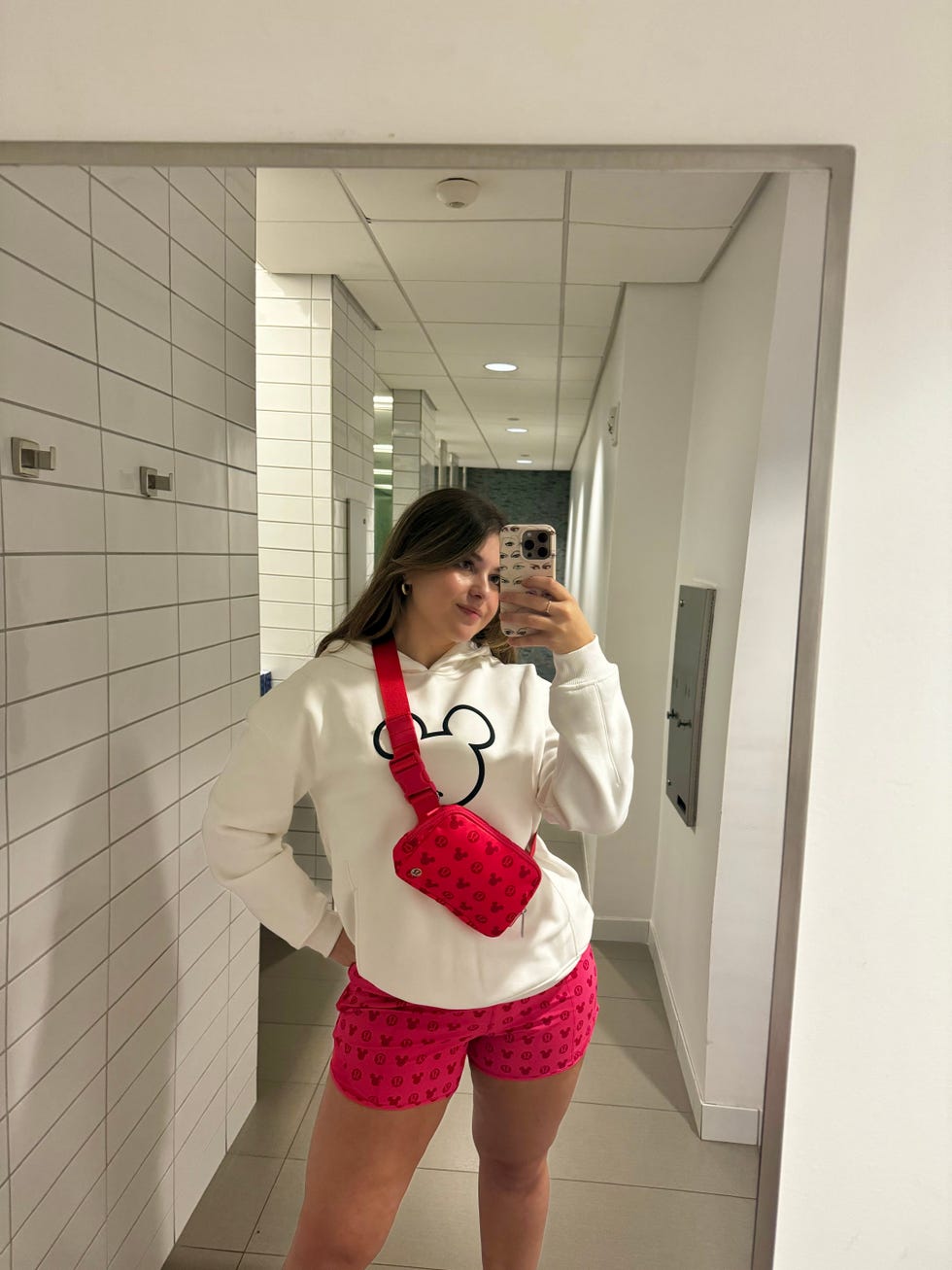 reflection in a mirror showing a person dressed in casual clothing