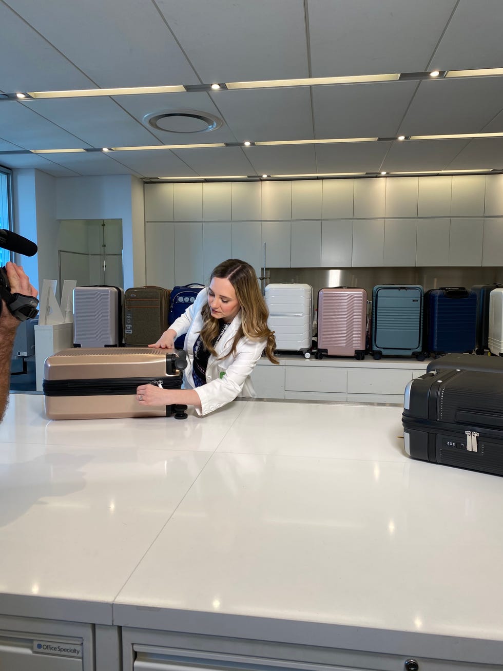 textiles lab director lexie sachs opens a suitcase as a part of luggage testing