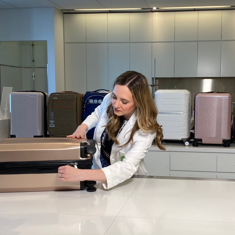 opening and closing luggage in Lab textiles lab director lexie sachs opens a suitcase as a part of luggage testing