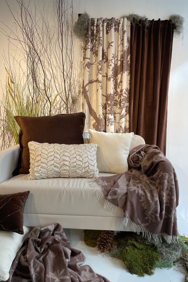 cozy seating area with textured pillows and throws surrounded by natural elements cozy seating area with textured pillows and throws surrounded by natural elements