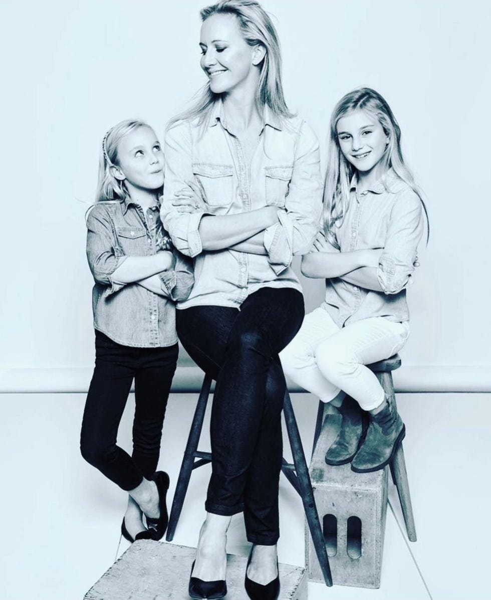 a woman and two children posing in matching outfits