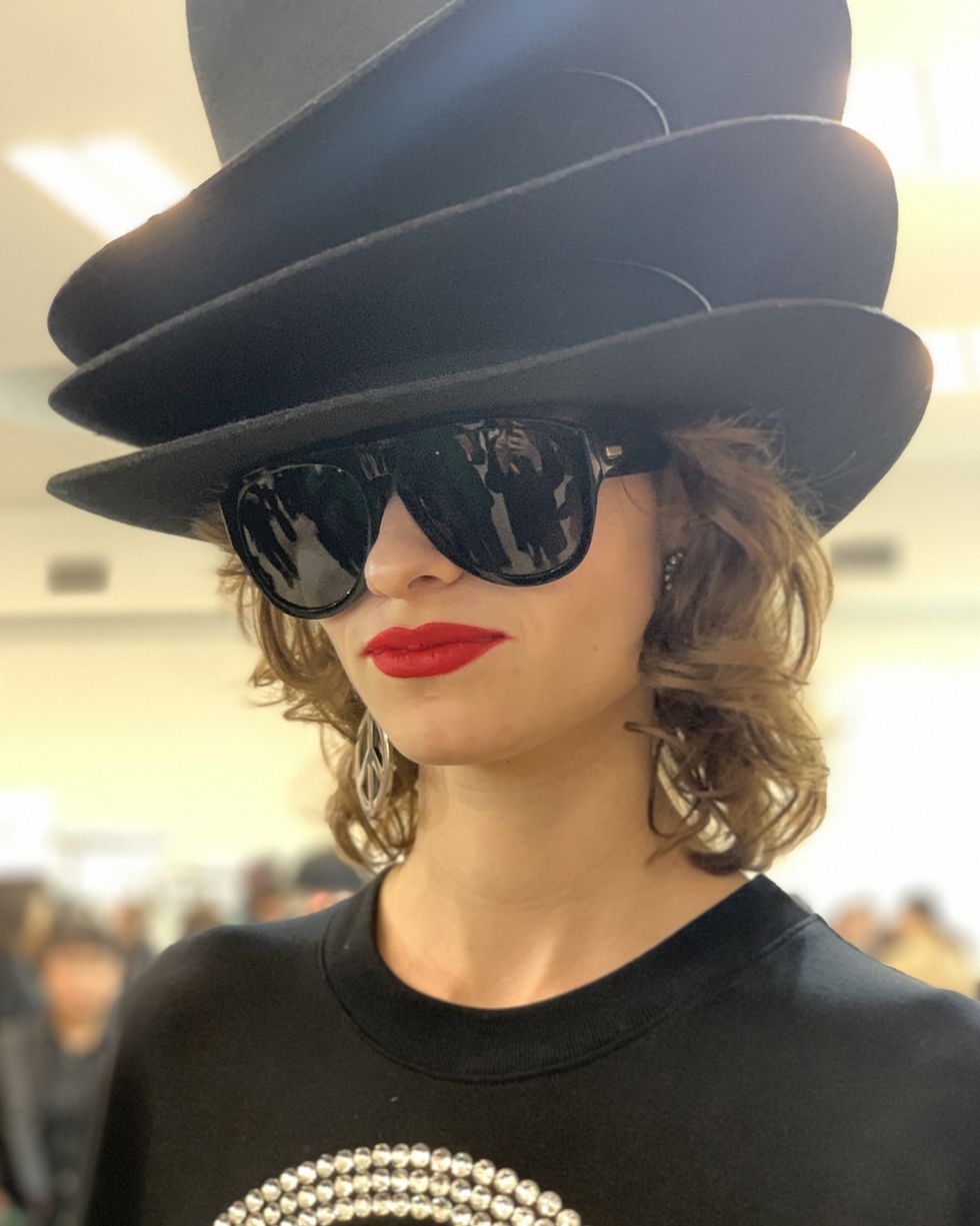 a person wearing a hat and sunglasses