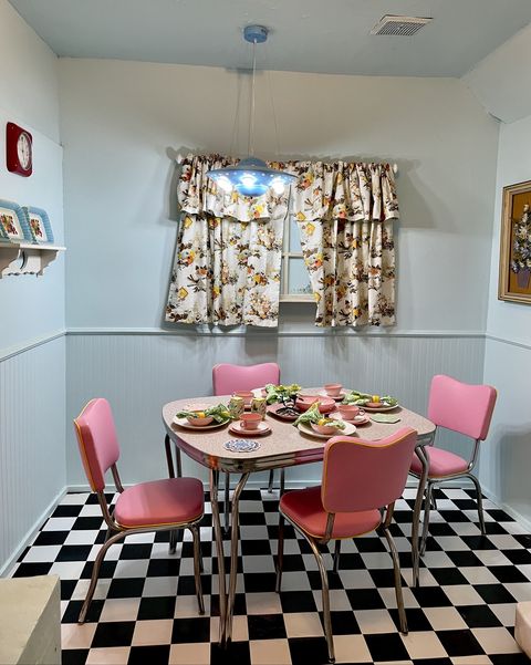 1950s kitchen with pink chairs and checkerboard flooring