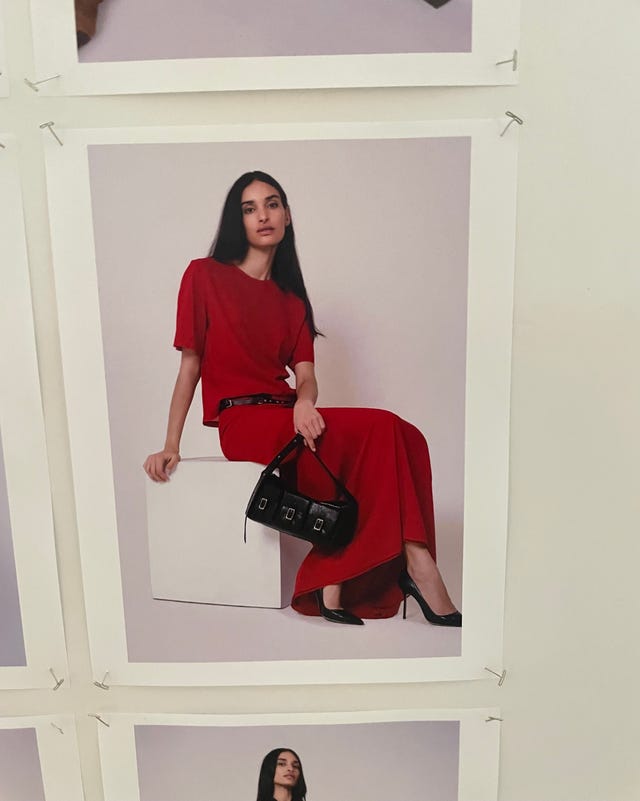 fashion model in a red outfit with a black handbag fashion model in a red outfit with a black handbag