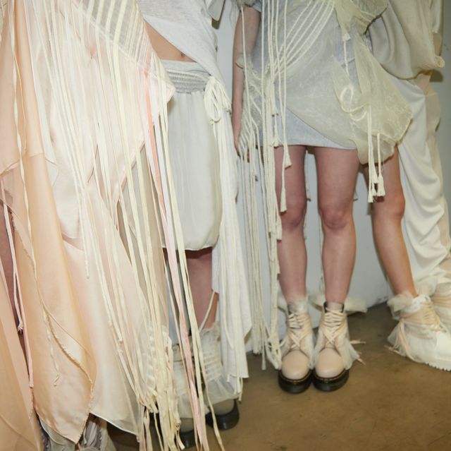 a group of mannequins wearing white clothes