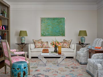 living room with white walls and sofa and green artwork