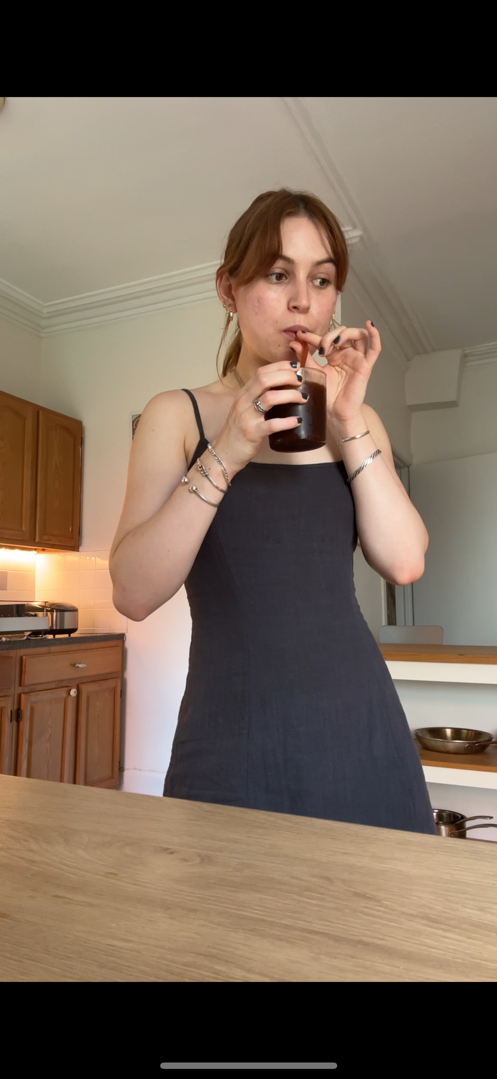 a woman drinking from a glass