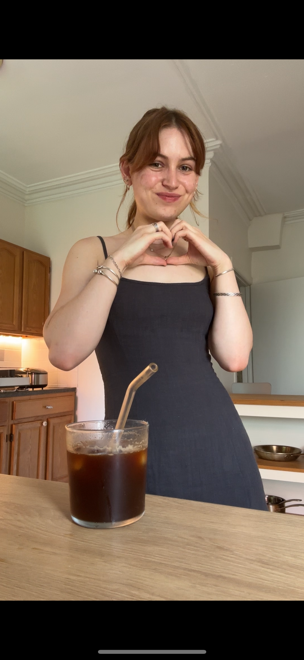 a woman holding a drink