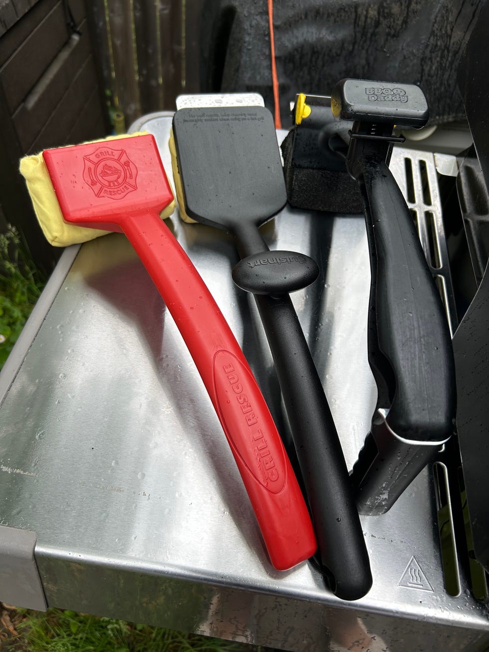 various grilling utensils arranged on a surface