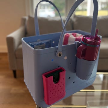 Bogg Bag Review: Bogg Bag Original large blue bogg bag with various accessories on a table
