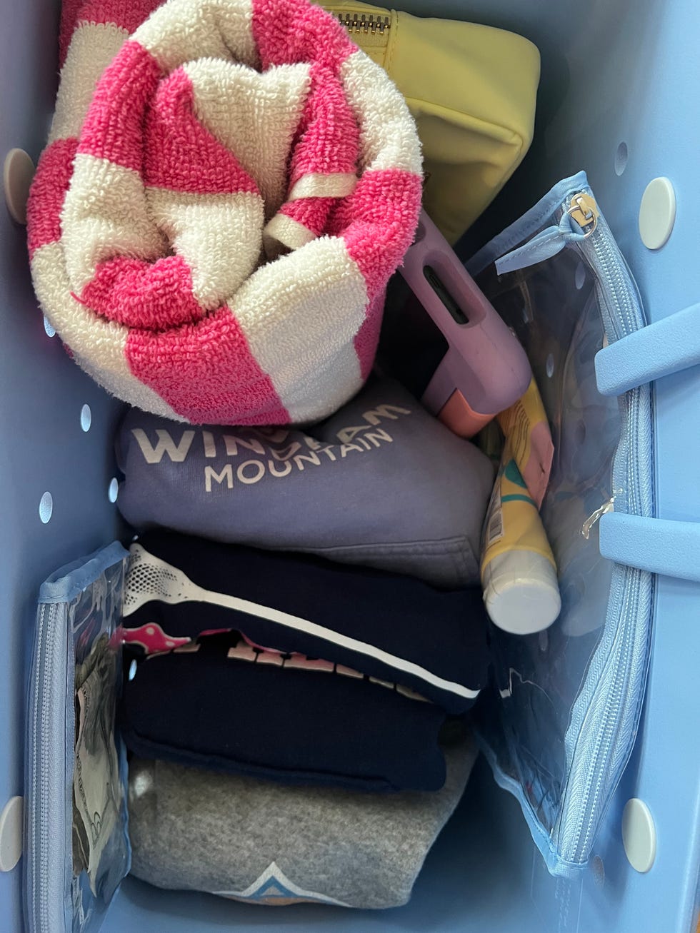 clothes, towel and other items in a blue bogg bag