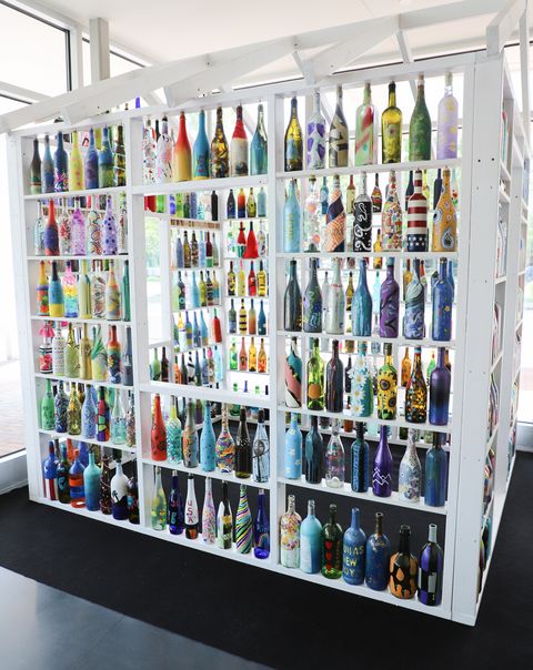 a community in williamsburg, virginia creates a “stay at home” art installation built by resident painted wine bottles