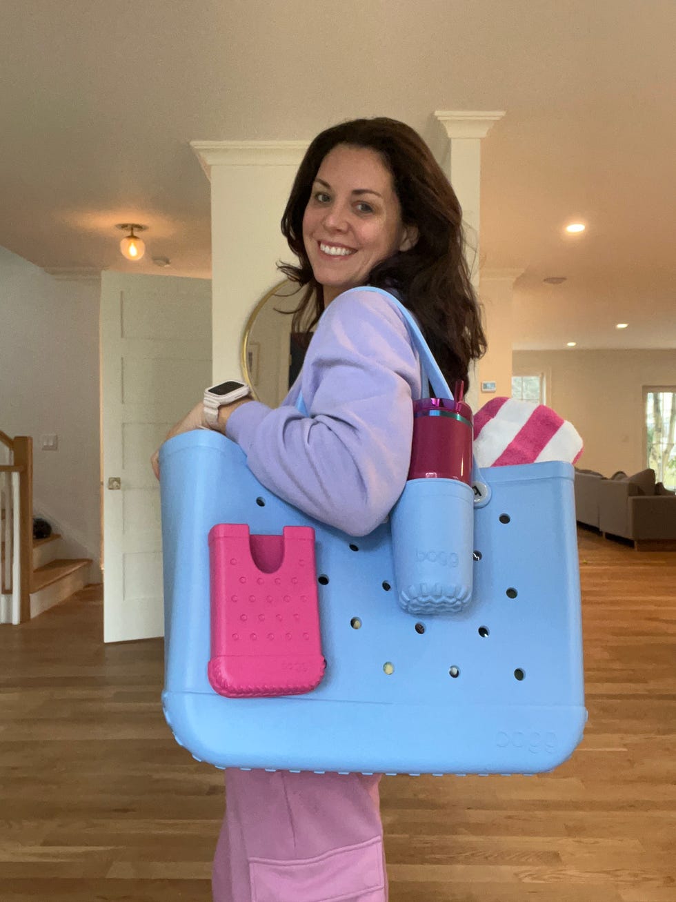 woman carrying a large blue tote bag