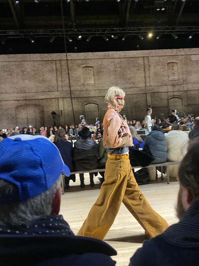 runway model showcasing a fashion outfit during a show