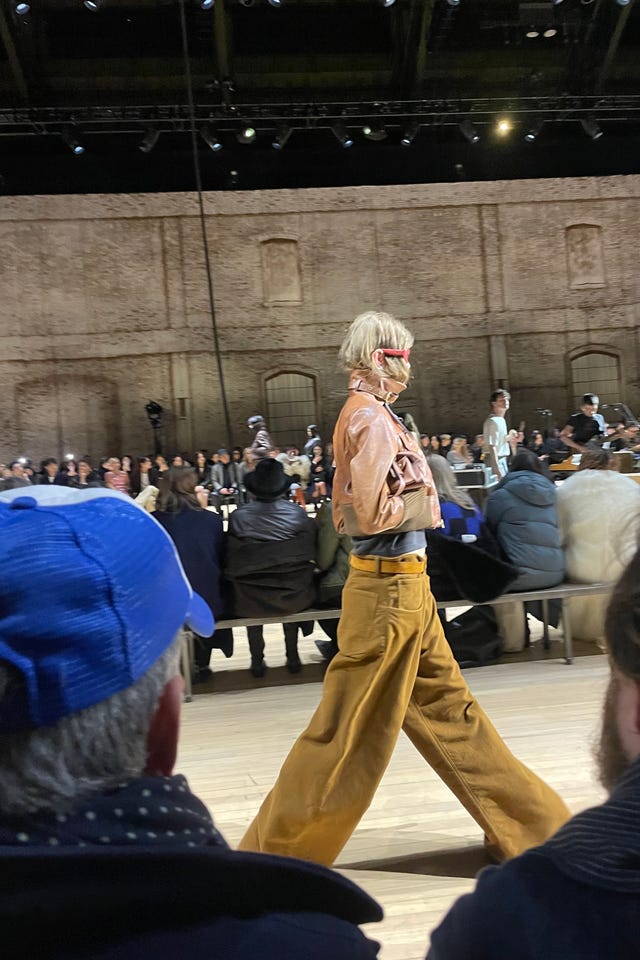 runway model showcasing a fashion outfit during a show runway model showcasing a fashion outfit during a show