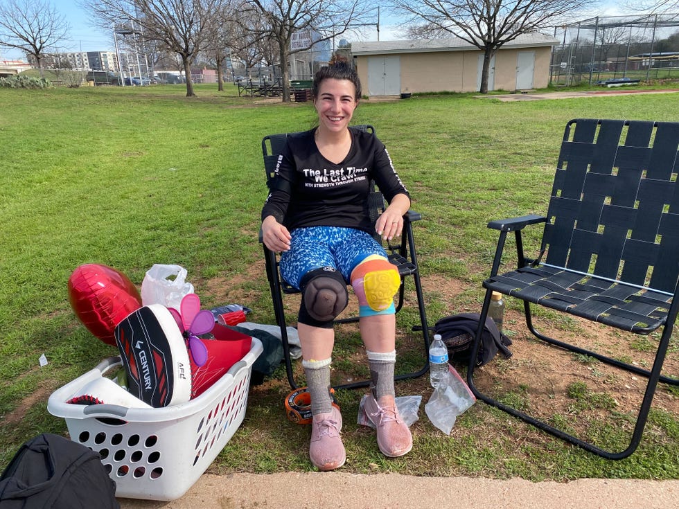 summer willis sitting in a chair with sports gear and accessories around them