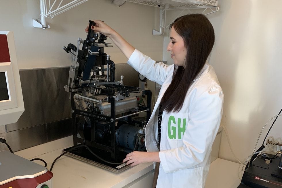 emma seymour loads samples into the wyzebeck abrasion tester to evaluate fabric durability to find the best travel backpacks