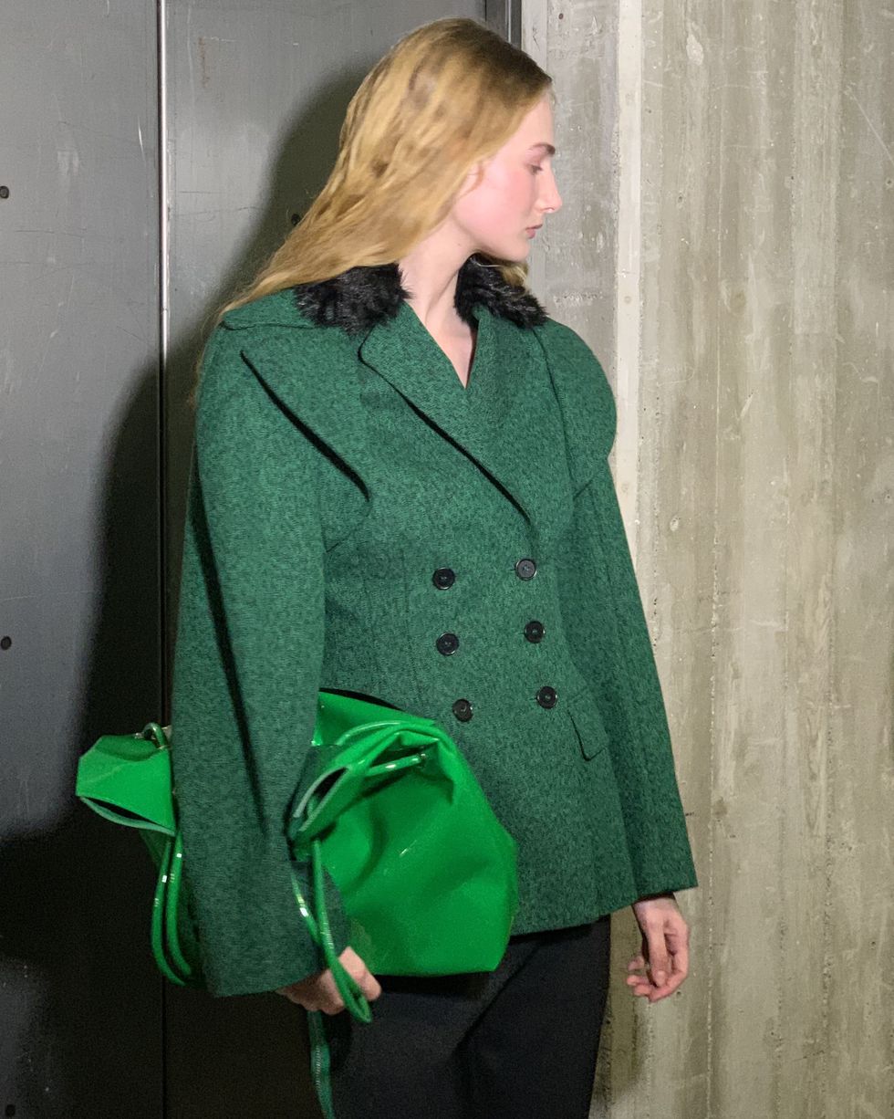 a woman wearing a green coat