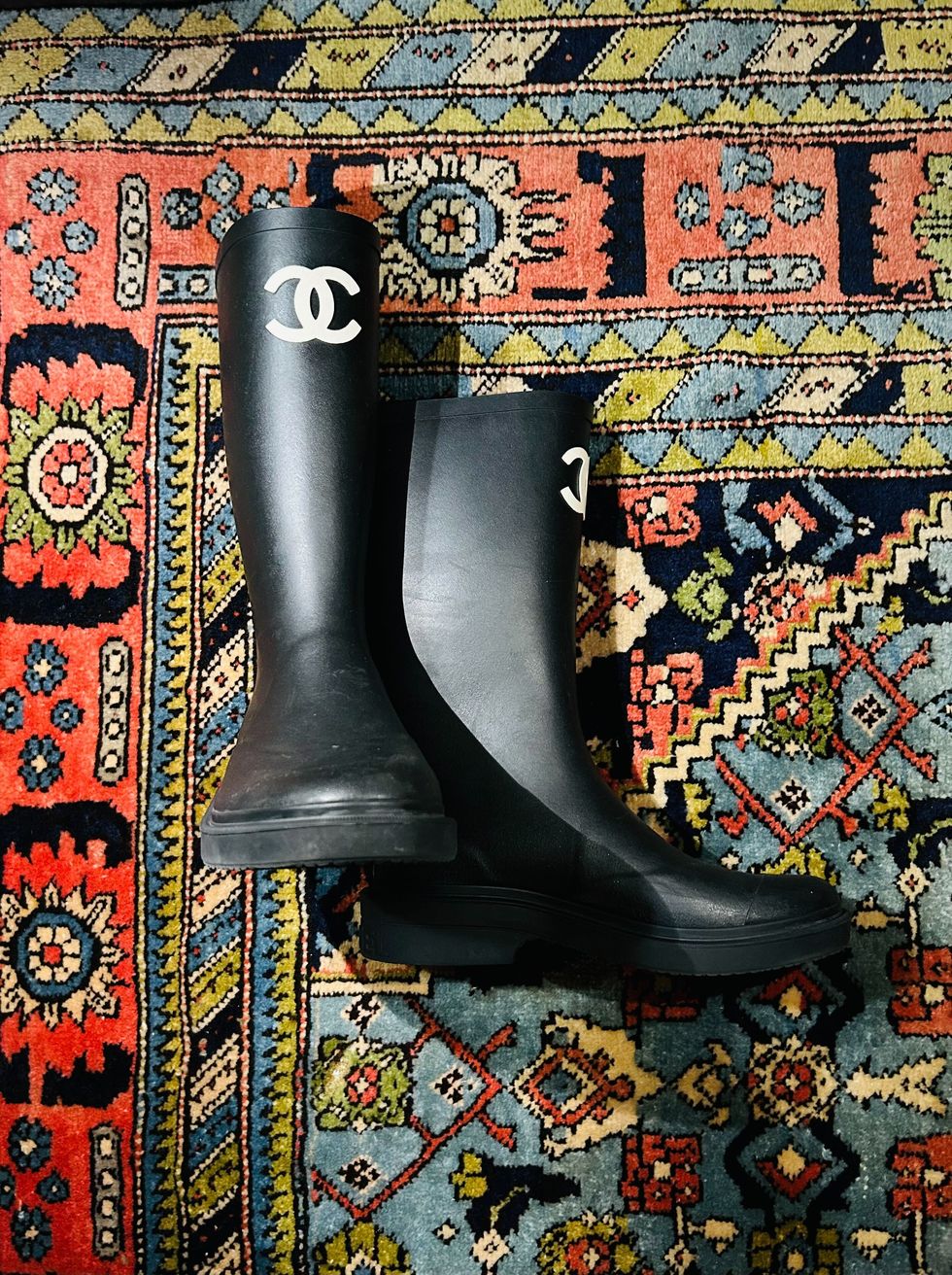 a pair of black boots on a colorful surface