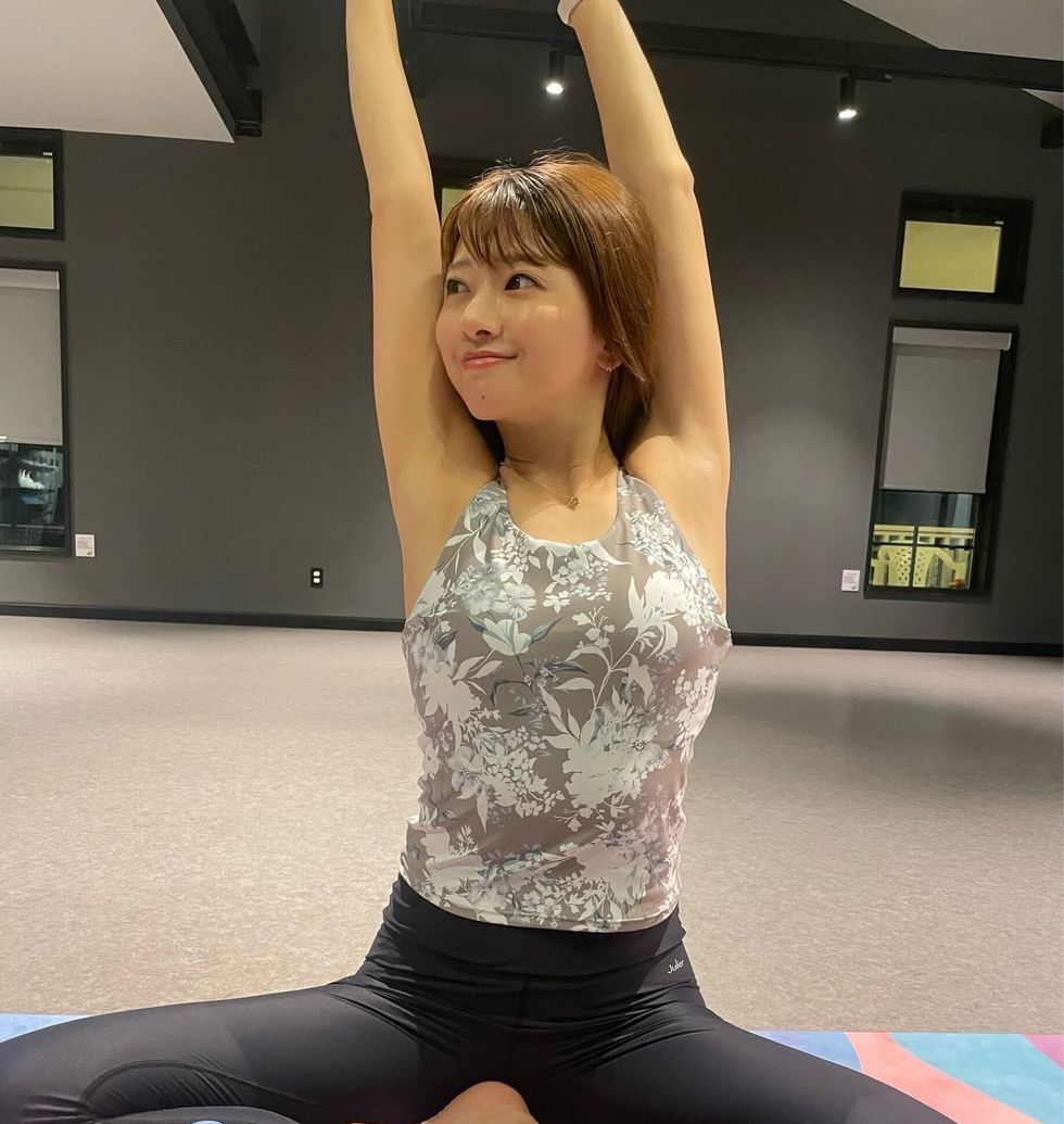 a woman sitting on a yoga mat