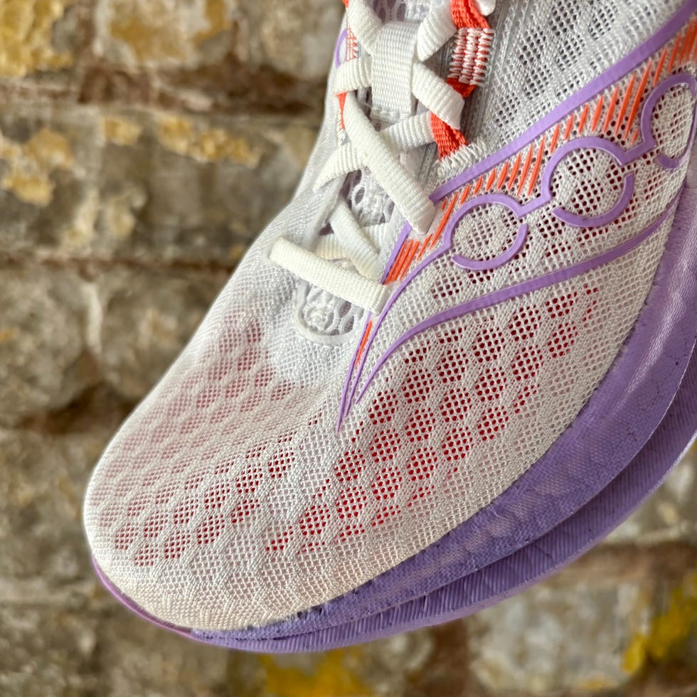 close up of the toe box of a shoe against a brick wall