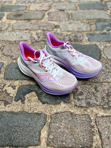 pair of running shoes on a cobbled pavement