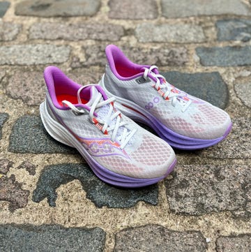 pair of running shoes on a cobbled pavement pair of running shoes on a cobbled pavement