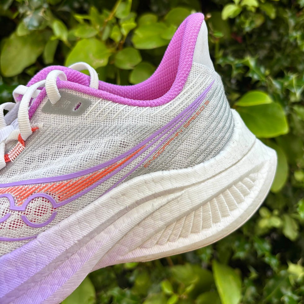 close up of the back of a shoe with foliage in the background