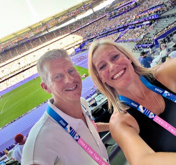 selfie taken at a sporting event with a stadium filled with spectators in the background