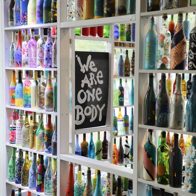 a community in williamsburg, virginia creates a “stay at home” art installation built by resident painted wine bottles