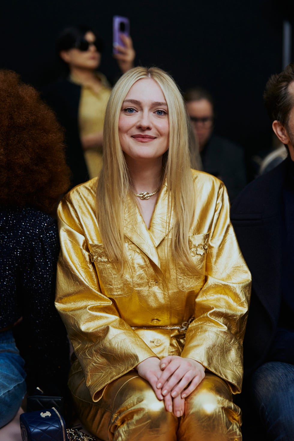 woman sitting in a gold suit woman sitting in a gold suit