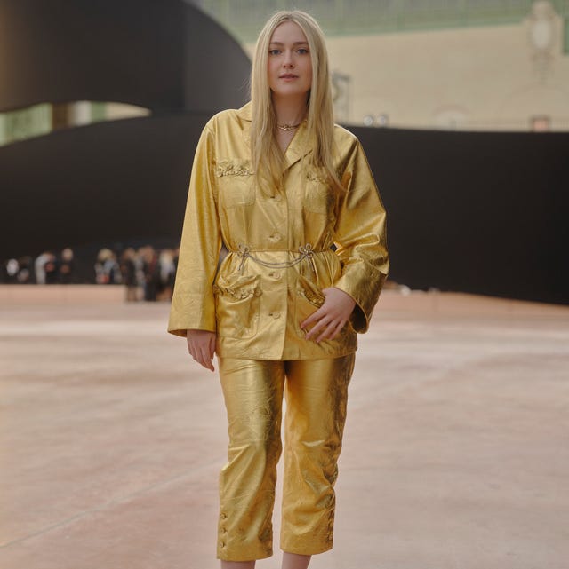 a person wearing a golden outfit and high heels poses in a fashion setting a person wearing a golden outfit and high heels poses in a fashion setting