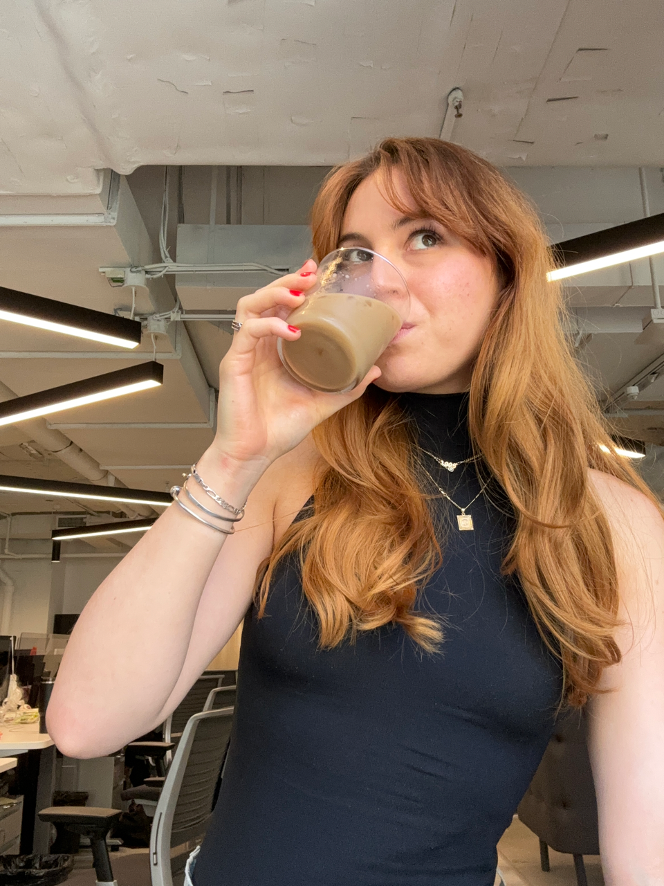 a woman drinking from a glass