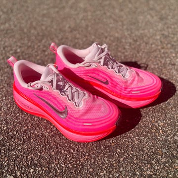 a pair of running shoes on a pavement a pair of running shoes on a pavement